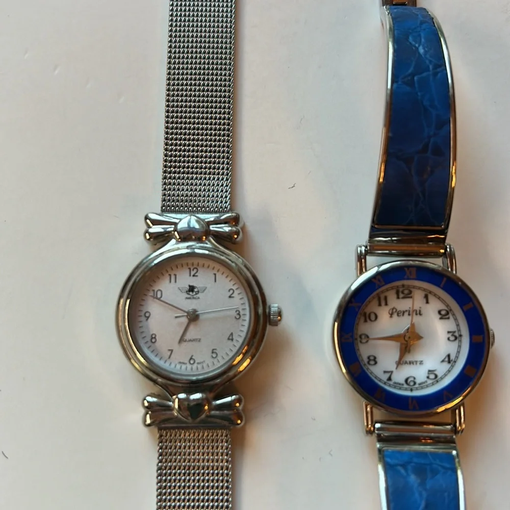 Two vintage quartz watches one stainless steel with hearts one with blue trim
